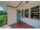 Inviting front porch featuring a brick floor, white brick columns and attractive blue door at 1399 Pollard Sw Dr, Atlanta, GA 30311