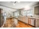 Open kitchen features stainless appliances, hardwood floors, and eat-in dining area at 1399 Pollard Sw Dr, Atlanta, GA 30311