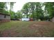 Large backyard with grass and mature trees at 208 Holiday Way, Carrollton, GA 30116