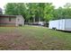 Spacious backyard of a home, with grass and multiple trees at 208 Holiday Way, Carrollton, GA 30116