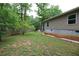 Large grassy backyard of a single-story home with a wood fence line at 208 Holiday Way, Carrollton, GA 30116