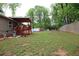 View of a large grassy backyard and wooden deck of a single-story home at 208 Holiday Way, Carrollton, GA 30116