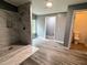 This bathroom boasts modern gray walls, light wood floors, and a tiled shower at 208 Holiday Way, Carrollton, GA 30116