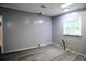 Bedroom with a window, light gray walls, hardwood floors, and overhead lighting at 208 Holiday Way, Carrollton, GA 30116