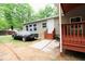 View of the exterior and side yard of a single story home with tan siding and wood stairs at 208 Holiday Way, Carrollton, GA 30116