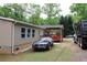 Exterior view of a single story home with tan siding and wood stairs at 208 Holiday Way, Carrollton, GA 30116