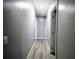 Long hallway with doors to rooms and closets, plus modern light wood floors at 208 Holiday Way, Carrollton, GA 30116