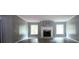 A bright living room with a decorative fireplace, light gray walls, and hardwood floors at 208 Holiday Way, Carrollton, GA 30116