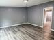This living room offers modern light wood floors and updated gray walls at 208 Holiday Way, Carrollton, GA 30116