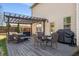 Enjoy this home's back deck with pergola, patio seating, and grill at 4215 Idlewood Dr, Cumming, GA 30040