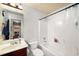 Well-lit bathroom with a vanity, tub, shower, and stylish patterned wallpaper at 4215 Idlewood Dr, Cumming, GA 30040