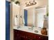 Bathroom vanity features a dark wood cabinet, granite countertop, and modern fixtures at 4215 Idlewood Dr, Cumming, GA 30040