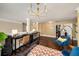Bright bedroom features a bed, an accent chair, a large window, and hardwood flooring throughout at 4215 Idlewood Dr, Cumming, GA 30040
