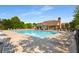 A sparkling community pool with lounge chairs, umbrellas, and clubhouse at 4215 Idlewood Dr, Cumming, GA 30040
