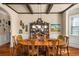 Formal dining room with hardwood floors, wood beams, and a large wood table for elegant meals at 4215 Idlewood Dr, Cumming, GA 30040