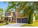 Brick home with a two-car garage, well-kept lawn, an American flag and covered porch at 4215 Idlewood Dr, Cumming, GA 30040