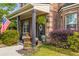 Charming front porch featuring potted plants, American flag, and decorative door with glass at 4215 Idlewood Dr, Cumming, GA 30040