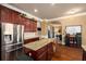 Modern kitchen with stainless steel refrigerator, large island, and hardwood floors at 4215 Idlewood Dr, Cumming, GA 30040