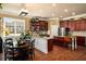 Bright kitchen with granite countertops, stainless steel appliances, and dark wood cabinets at 4215 Idlewood Dr, Cumming, GA 30040