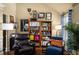 Comfortable living room featuring a bookshelf, accent chairs, a palm, and natural light at 4215 Idlewood Dr, Cumming, GA 30040