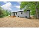 View shows a wood deck, grey siding, and a lush tree in the backyard at 4901 Prince Se Rd, Smyrna, GA 30082