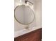 Contemporary bathroom boasts modern vanity with wood accents, stylish gold faucet, and a round mirror at 4901 Prince Se Rd, Smyrna, GA 30082