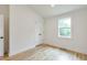 Bright bedroom with hardwood floors, white trim, a double-door closet, and a window at 4901 Prince Se Rd, Smyrna, GA 30082
