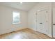 Bright bedroom with hardwood floors, white trim, a double-door closet, and a window at 4901 Prince Se Rd, Smyrna, GA 30082