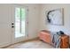 Bright entryway with a stylish bench, modern artwork, and natural light from the front door window at 4901 Prince Se Rd, Smyrna, GA 30082