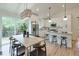 Open-concept kitchen and dining area featuring white cabinets, stainless steel appliances, and a large island at 4901 Prince Se Rd, Smyrna, GA 30082