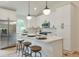 Stylish kitchen with white cabinets, a stainless steel fridge, and bar stool seating at the island at 4901 Prince Se Rd, Smyrna, GA 30082