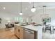 Bright kitchen island with stainless steel appliances, white cabinets, and hardwood floors at 4901 Prince Se Rd, Smyrna, GA 30082