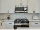A chef's kitchen featuring a stainless steel microwave and range, along with white subway tile at 4901 Prince Se Rd, Smyrna, GA 30082