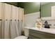 Clean bathroom showcasing vanity with sink, toilet, and decorative shower curtain at 114 Summer Glen Pl, Dallas, GA 30157