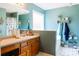 Bright bathroom featuring a vanity, large mirror, and shower-tub combo at 114 Summer Glen Pl, Dallas, GA 30157