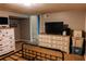 Bedroom featuring vintage-style dressers, TV, and ample storage, combining comfort and functionality at 114 Summer Glen Pl, Dallas, GA 30157