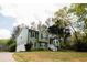 Green two-story home with a two-car garage and mature trees at 114 Summer Glen Pl, Dallas, GA 30157