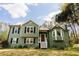 Charming green two-story home with classic white trim and well-maintained front yard at 114 Summer Glen Pl, Dallas, GA 30157