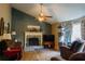 Warm living room with a vaulted ceiling, fireplace, and cozy seating area at 114 Summer Glen Pl, Dallas, GA 30157