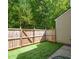 A low-maintenance backyard features artificial turf, string lights, and a wood privacy fence at 1575 Kilmington Ct, Alpharetta, GA 30009
