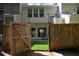 A fenced backyard has artificial turf and an outdoor seating area perfect for entertaining at 1575 Kilmington Ct, Alpharetta, GA 30009
