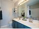 Stylish bathroom with double sinks, a large mirror, and modern fixtures at 1575 Kilmington Ct, Alpharetta, GA 30009