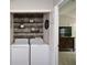 A laundry area features a full-size washer and dryer and decorative wood paneling at 1575 Kilmington Ct, Alpharetta, GA 30009