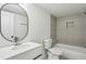 Modern bathroom featuring a stylish vanity, oval mirror, and tiled shower at 1721 Hortense Nw Pl, Atlanta, GA 30318