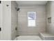 Bathroom showing a shower with tiled walls and a built-in bench at 1721 Hortense Nw Pl, Atlanta, GA 30318