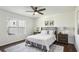 Cozy bedroom with a comfortable bed, neutral decor, a ceiling fan, and natural light from the windows at 1721 Hortense Nw Pl, Atlanta, GA 30318
