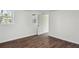 Bright bedroom with hardwood floors and an open doorway to a bedroom or closet at 1721 Hortense Nw Pl, Atlanta, GA 30318