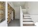 Entryway features stone wall, speckled floors, and wood stairs at 1721 Hortense Nw Pl, Atlanta, GA 30318