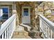 Inviting front entrance with stone steps and white railings leading to a classic white front door at 1721 Hortense Nw Pl, Atlanta, GA 30318