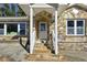 Close-up of the stone-accented front entrance with a bright white door and well-maintained steps and railings at 1721 Hortense Nw Pl, Atlanta, GA 30318